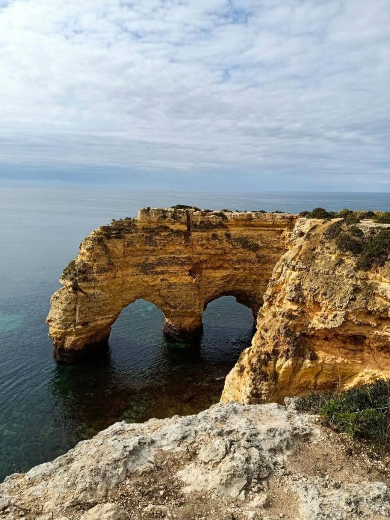 A view of the Arcos de Marinha rock formation from a cliff above.